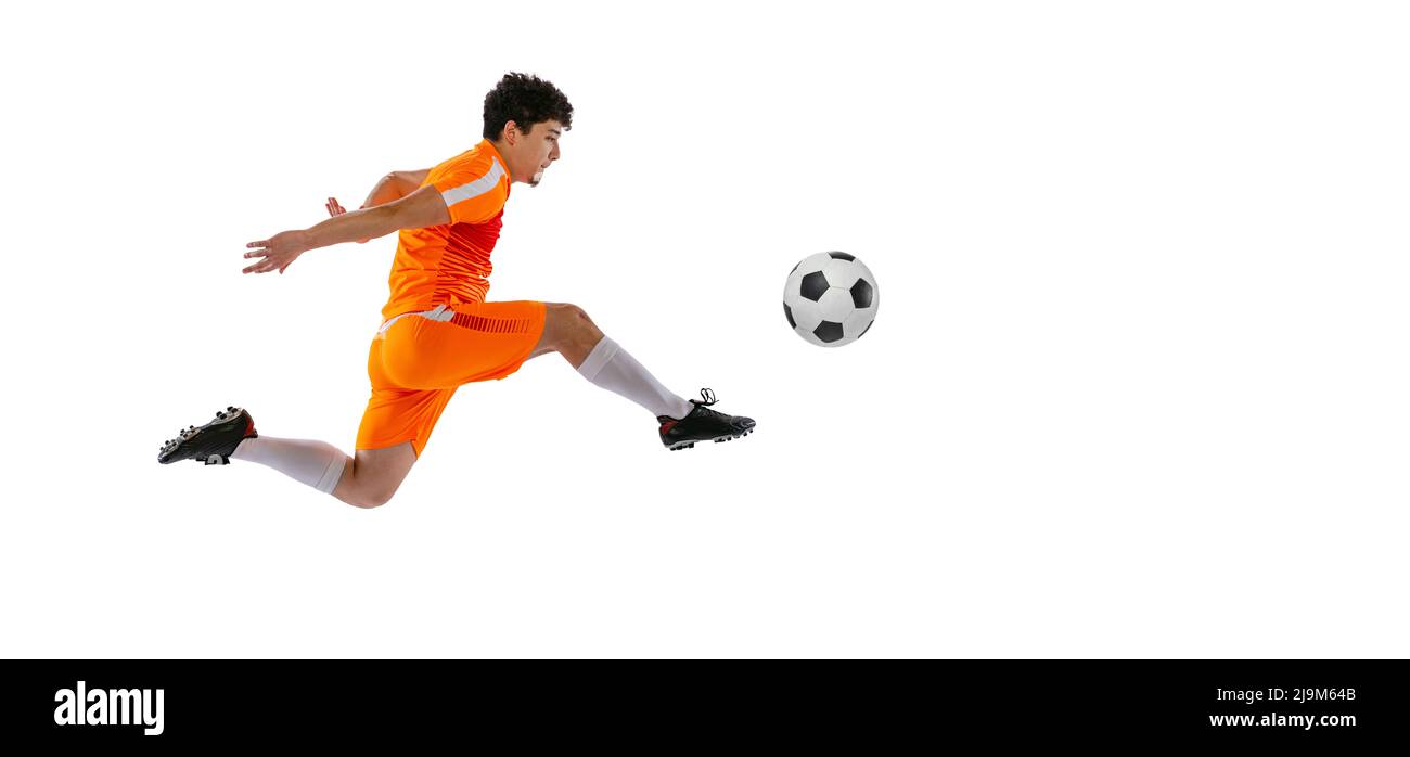 Professional football, soccer player in motion isolated on white studio background. Concept of sport, match, active lifestyle, goal and hobby Stock Photo