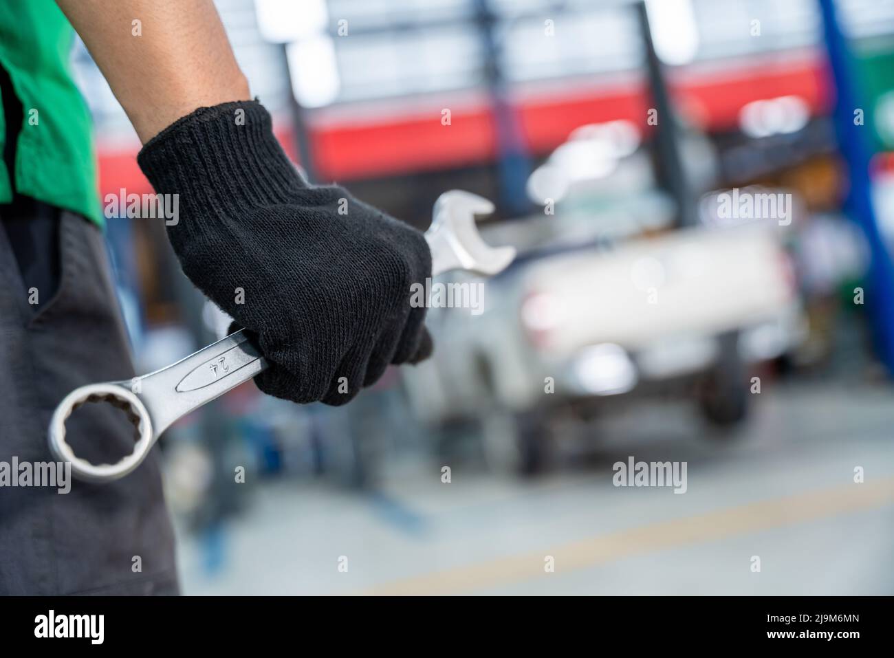 Auto Mechanic holding a wrench in Car repair service center Stock Photo