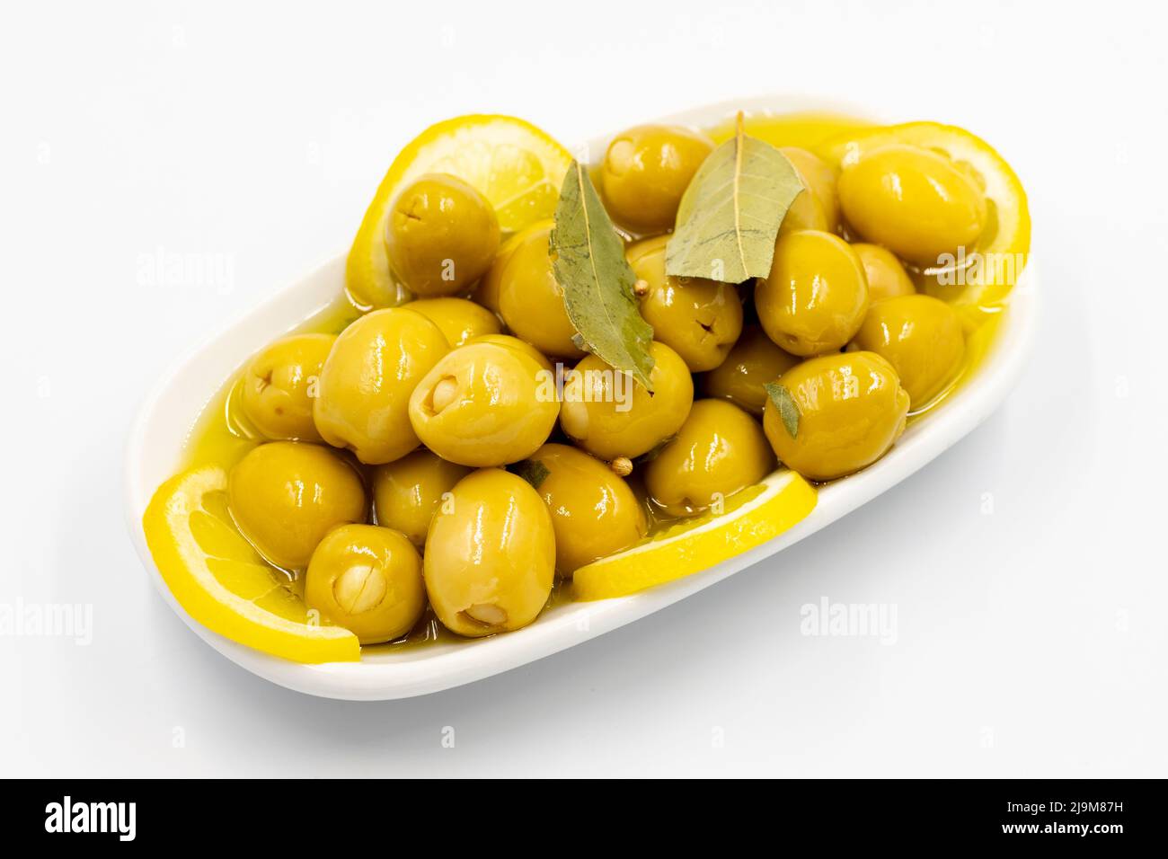 Green olives stuffed with cheese. Cheese filled olives for breakfast on isolated white