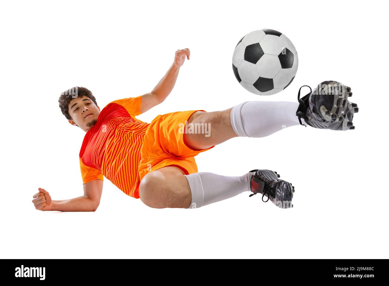 Professional football, soccer player in motion isolated on white studio background. Concept of sport, match, active lifestyle, goal and hobby. Wide Stock Photo