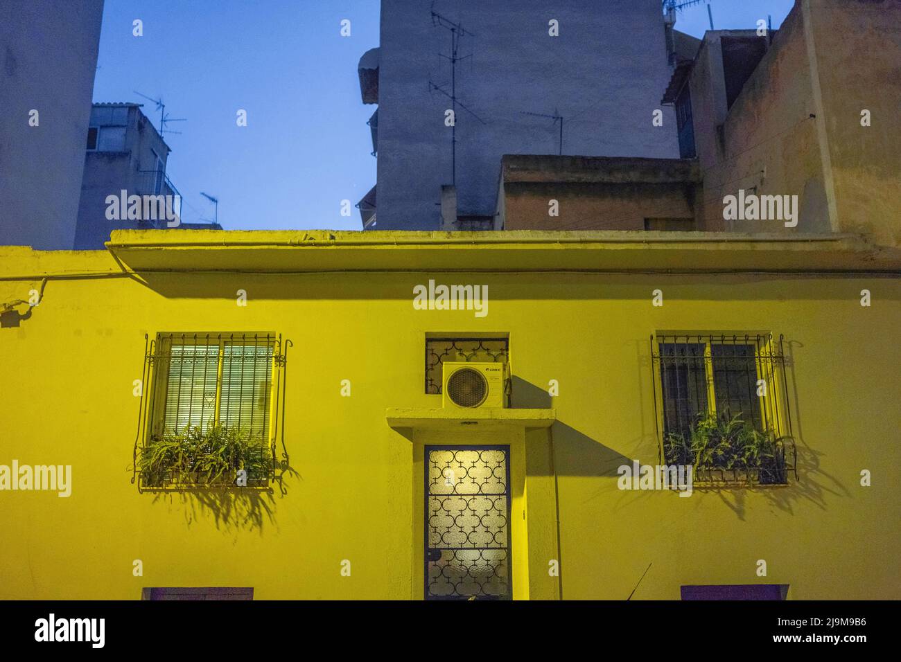 Yellow building illuminated at night, Kypseli, Athens Stock Photo Alamy