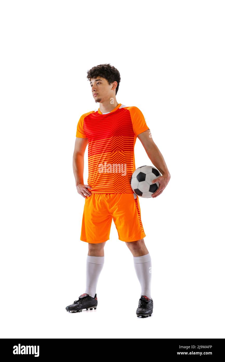 Portrait of young man, asian football, soccer player posing with ball isolated on white studio background. Concept of sport, match, active lifestyle Stock Photo