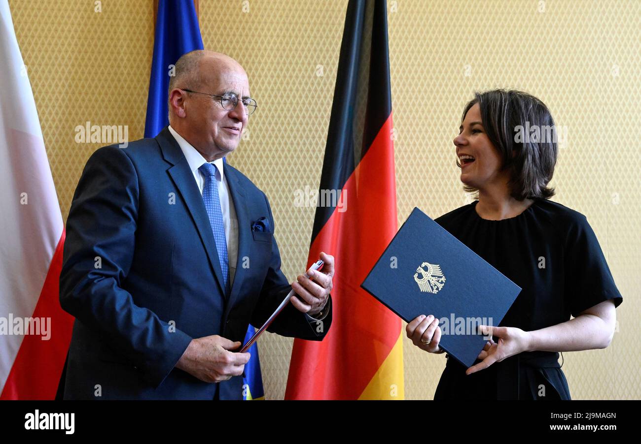 German Foreign Minister Annalena Baerbock and Polish Foreign Minister Zbigniew Rau react as they exchange documents after signing a 'Memorandum of Understanding' for the permanent financing of the International Youth Meeting Centre (IYMC) of the Kreisau Foundation for European Understanding, at the Foreign Office in Berlin, Germany May 24, 2022. Tobias Schwarz/Pool via REUTERS Stock Photo