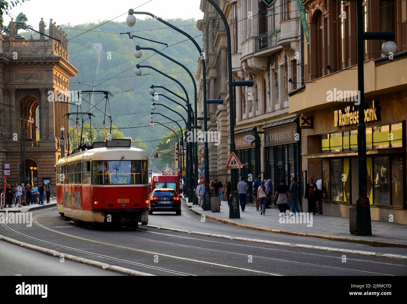 Beautiful landscape of a busy street, with old red tram on a sunny evening , captured at PRAGUE, CZECH REPUBLIC 0n  july 23, 2018 Stock Photo
