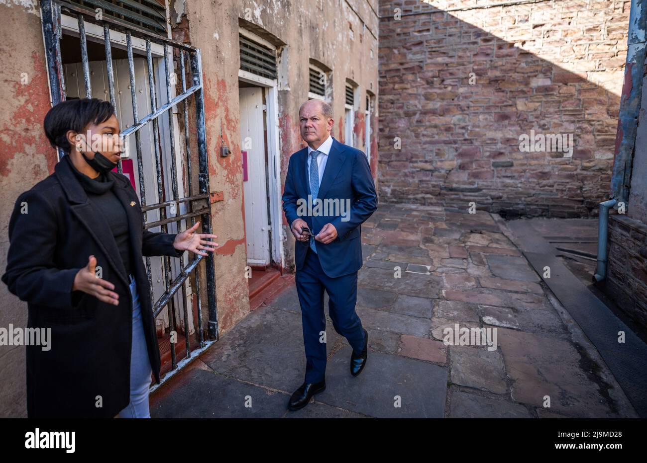 Johannesburg, South Africa. 24th May, 2022. German Chancellor Olaf Scholz (SPD), guided by Pearl Gugulethu, visits the former 'Number Four' prison, where numerous political prisoners were also incarcerated during apartheid. Like Germany, South Africa belongs to the G20 of the world's most important economic powers and has been invited by Scholz to the G7 summit at Schloss Elmau in Bavaria. Scholz had previously visited Niger and Senegal during his trip to Africa. Credit: Michael Kappeler/dpa/Alamy Live News Stock Photo