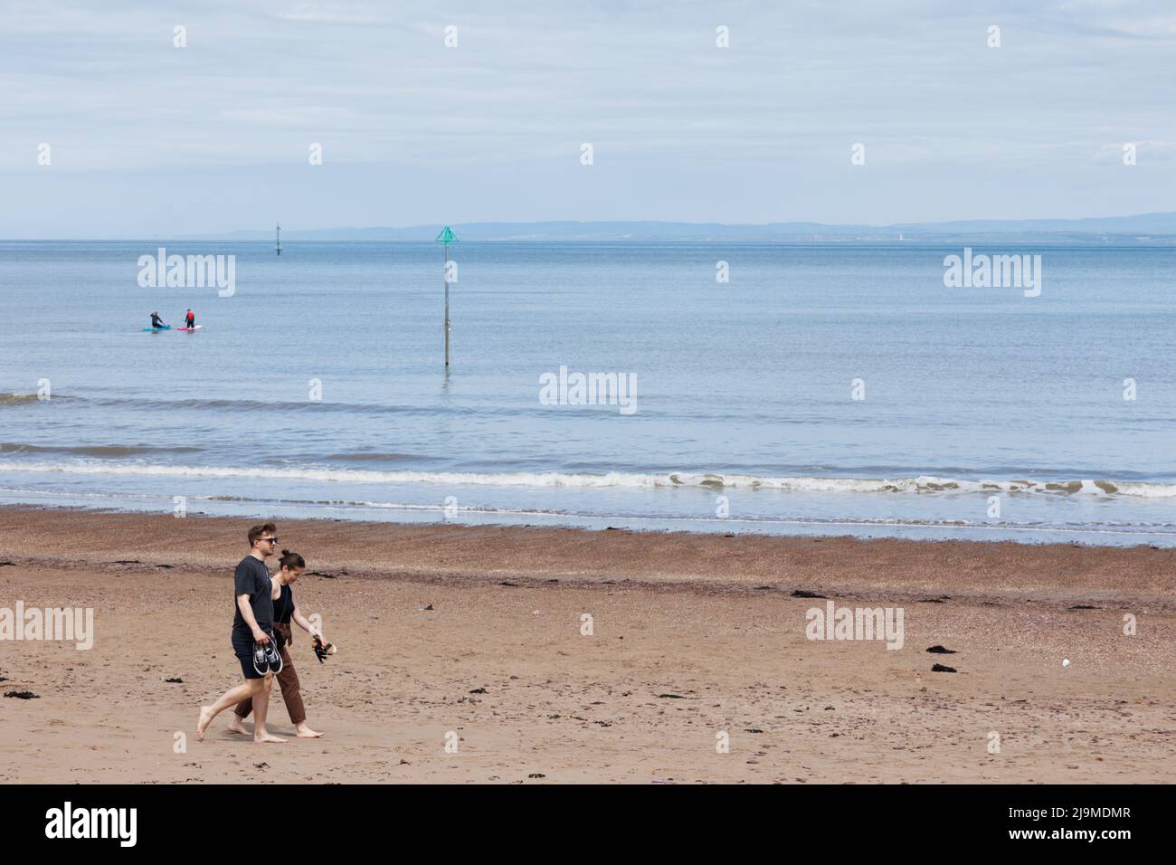 Minehead, Somerset, UK.  22 May 2022.  UK weather: People enjoy a walk along the coast this morning. Stock Photo