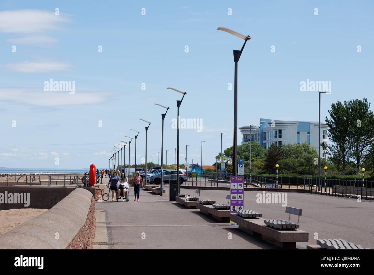 Minehead, Somerset, UK.  22 May 2022.  UK weather: People enjoy a walk along the coast this morning. Stock Photo