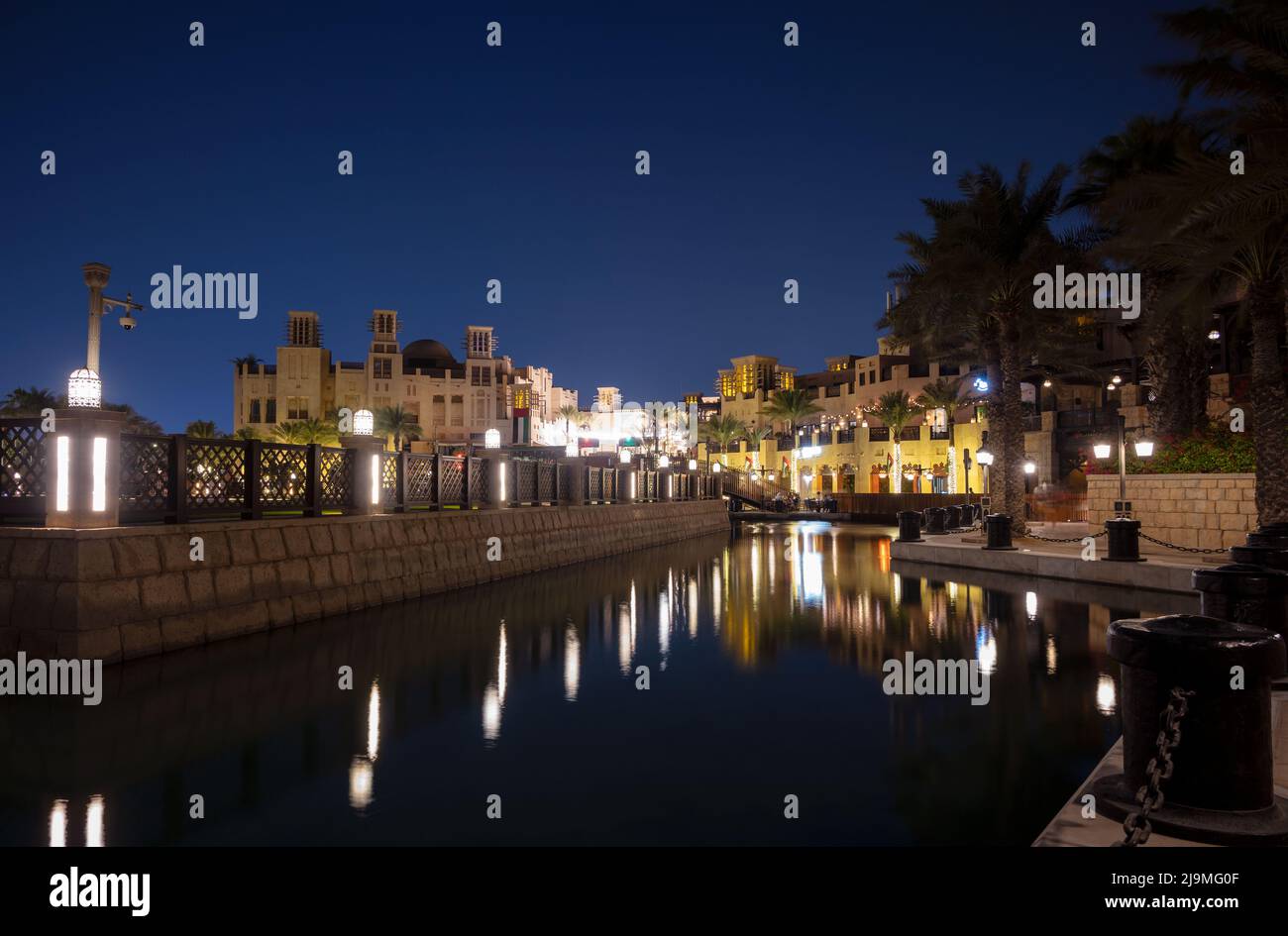 Night view of the illuminated artificial canal at the Souk Madinat Jumeirah which is a shopping mall designed in traditional Arabic style. Stock Photo
