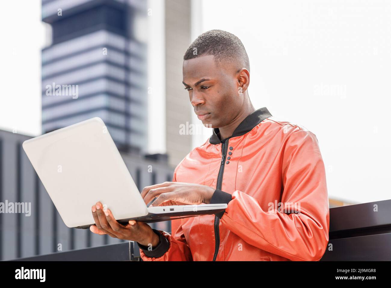 Side view of focused young African American male student in stylish ...