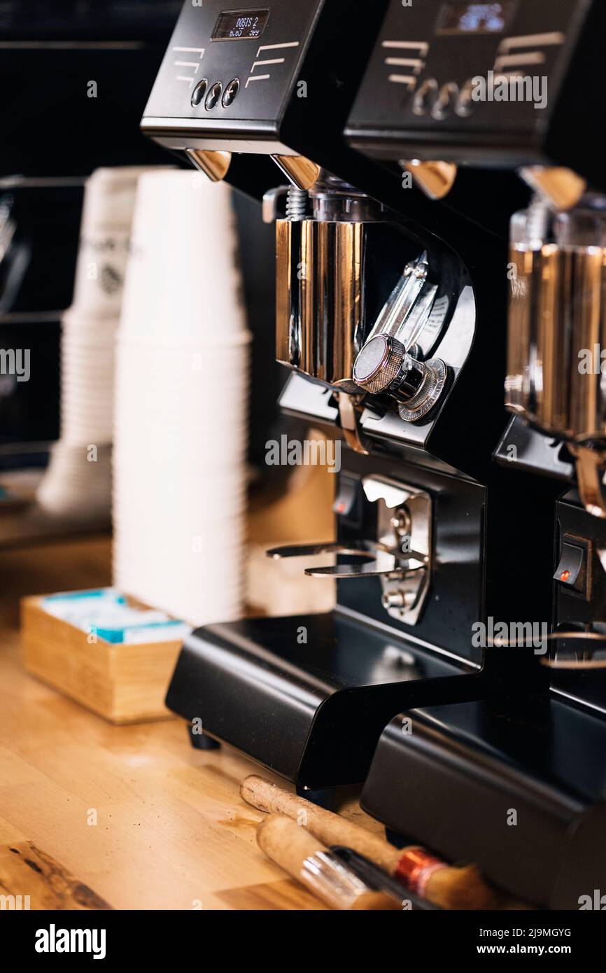 Contemporary black coffee makers with chrome details placed on wooden