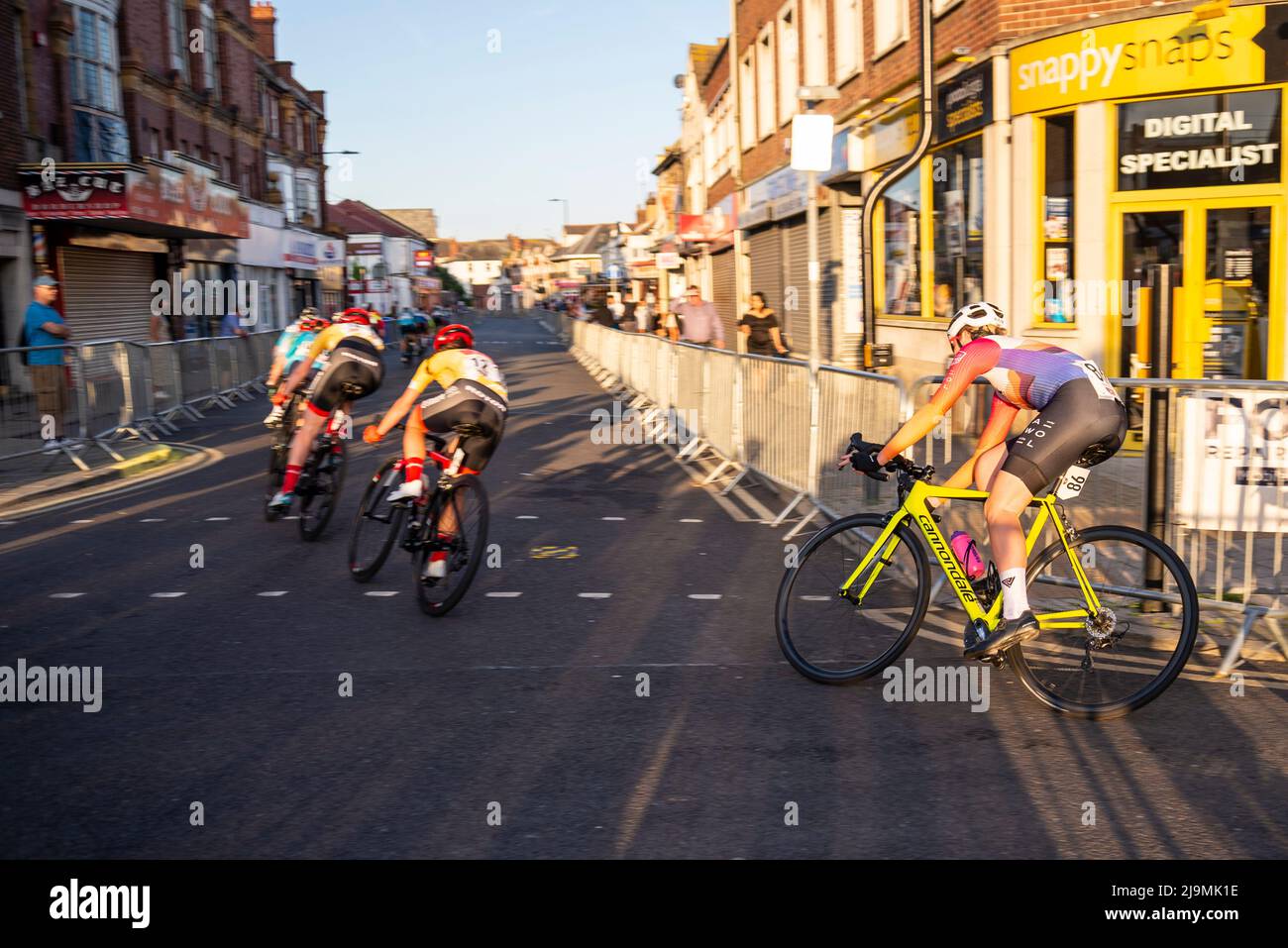 Female cyclists racing in the Sportsbreaks Tour Series Women's cycle race round five in Clacton on Sea, Essex, UK. Criterium street race in backstreet Stock Photo