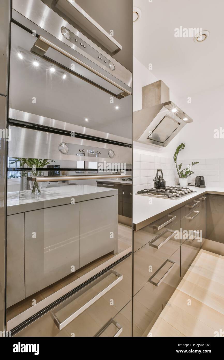 Modern electric cooking appliances and built in cabinets inside kitchen of  home Stock Photo - Alamy