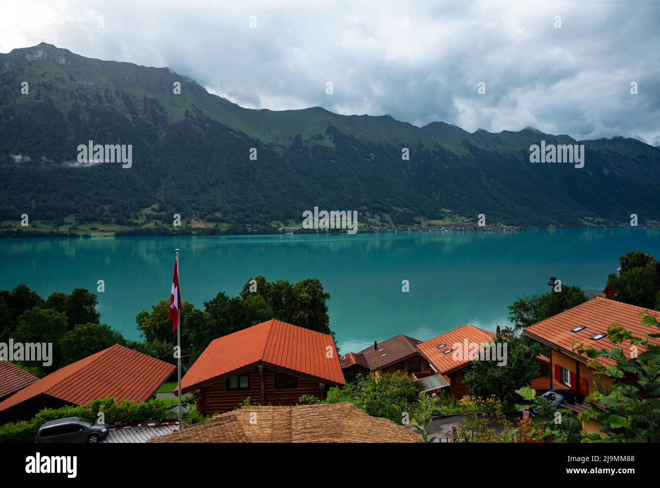 View of the red chalet wooden houses along the banks of lake brienz