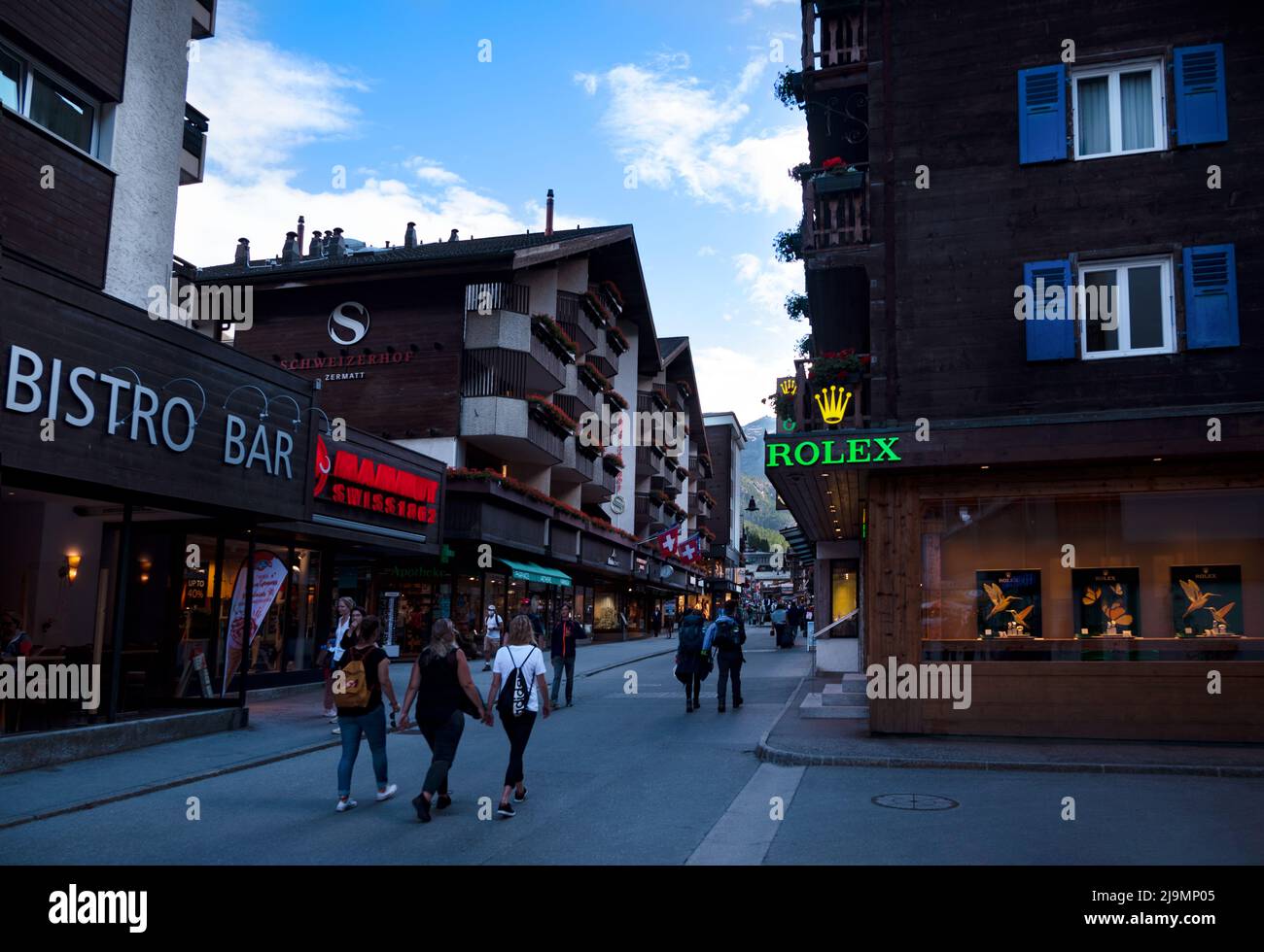 View of souvenir shops at the main shopping street of Zermatt a car