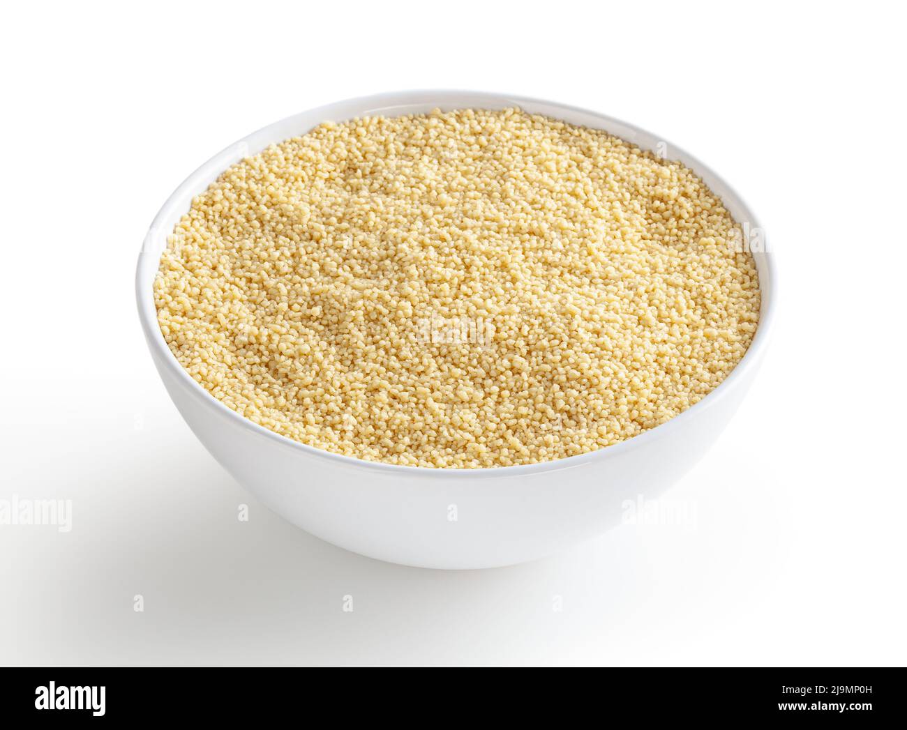 Uncooked cous cous in white bowl isolated on white background with clipping path Stock Photo