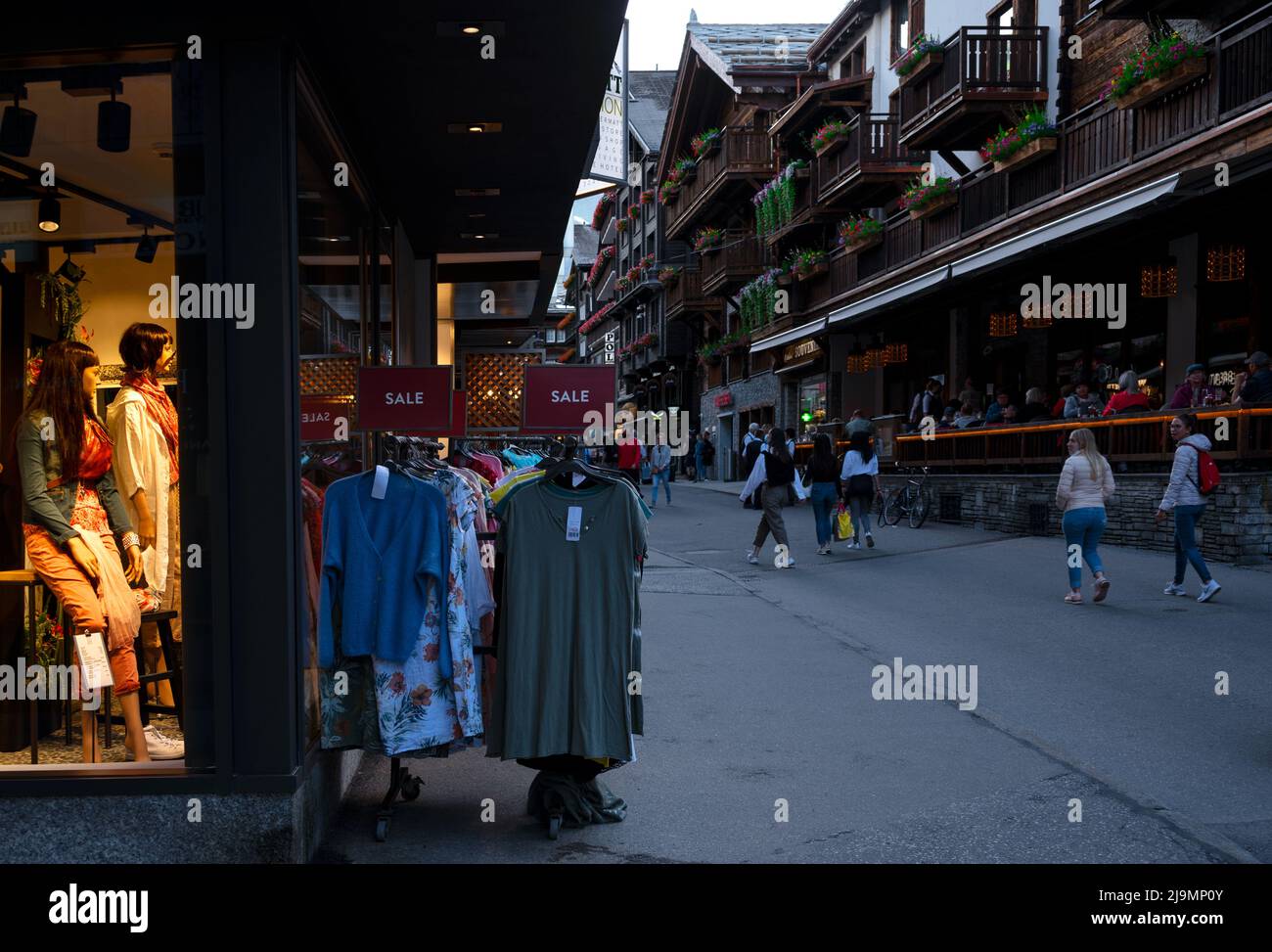 View of souvenir shops at the main shopping street of Zermatt a car