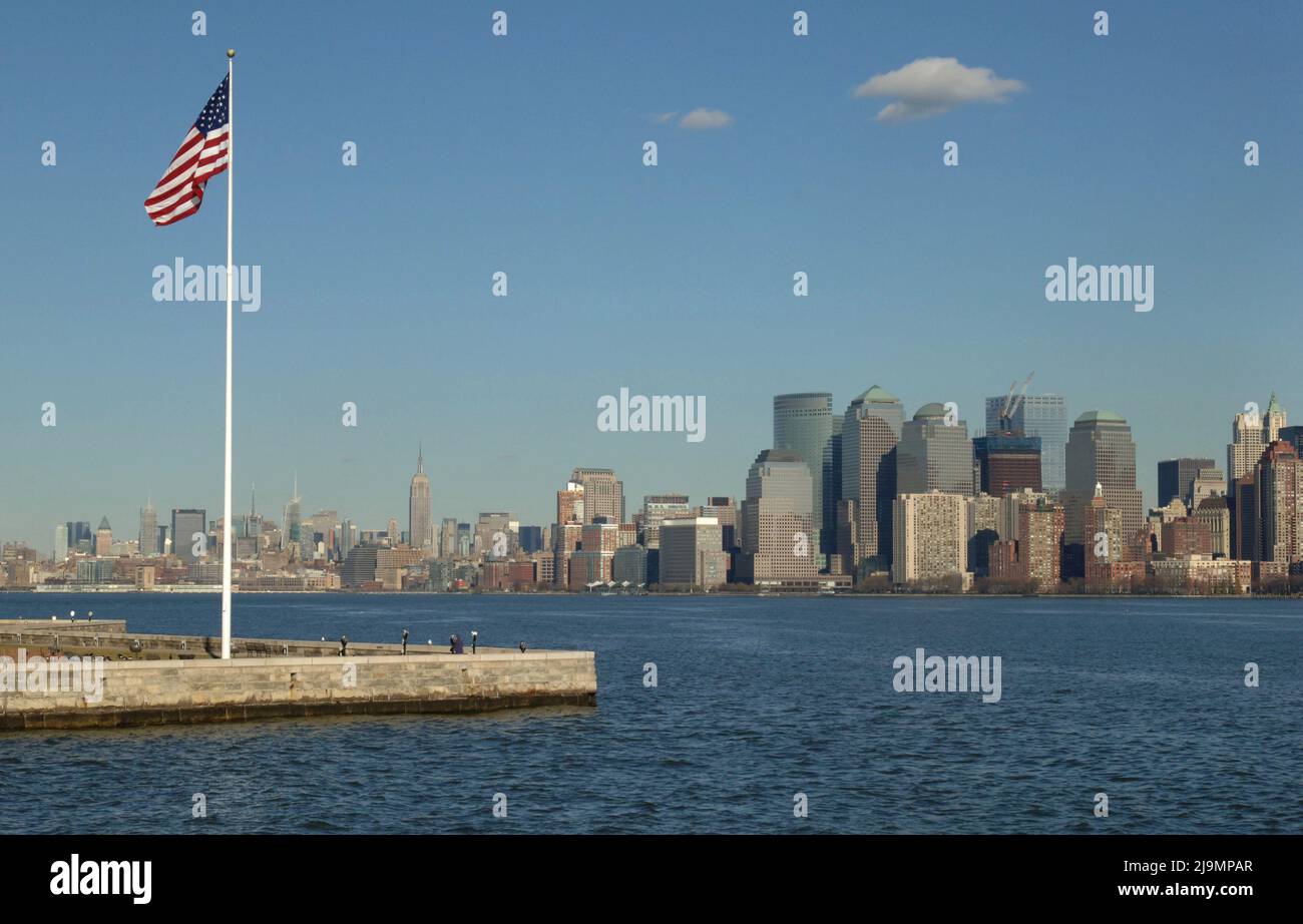New York Skyline with the Stars and Stripes Flag in the Foreground. Stock Photo