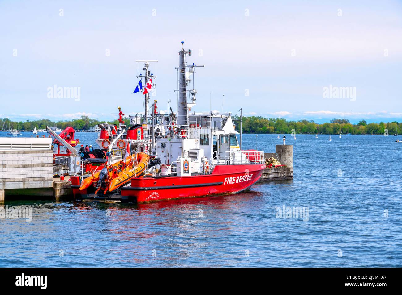 A fire rescue boat is moored in the city waterfront. The water vehicle serves incidents happening in the Lake Ontario Stock Photo