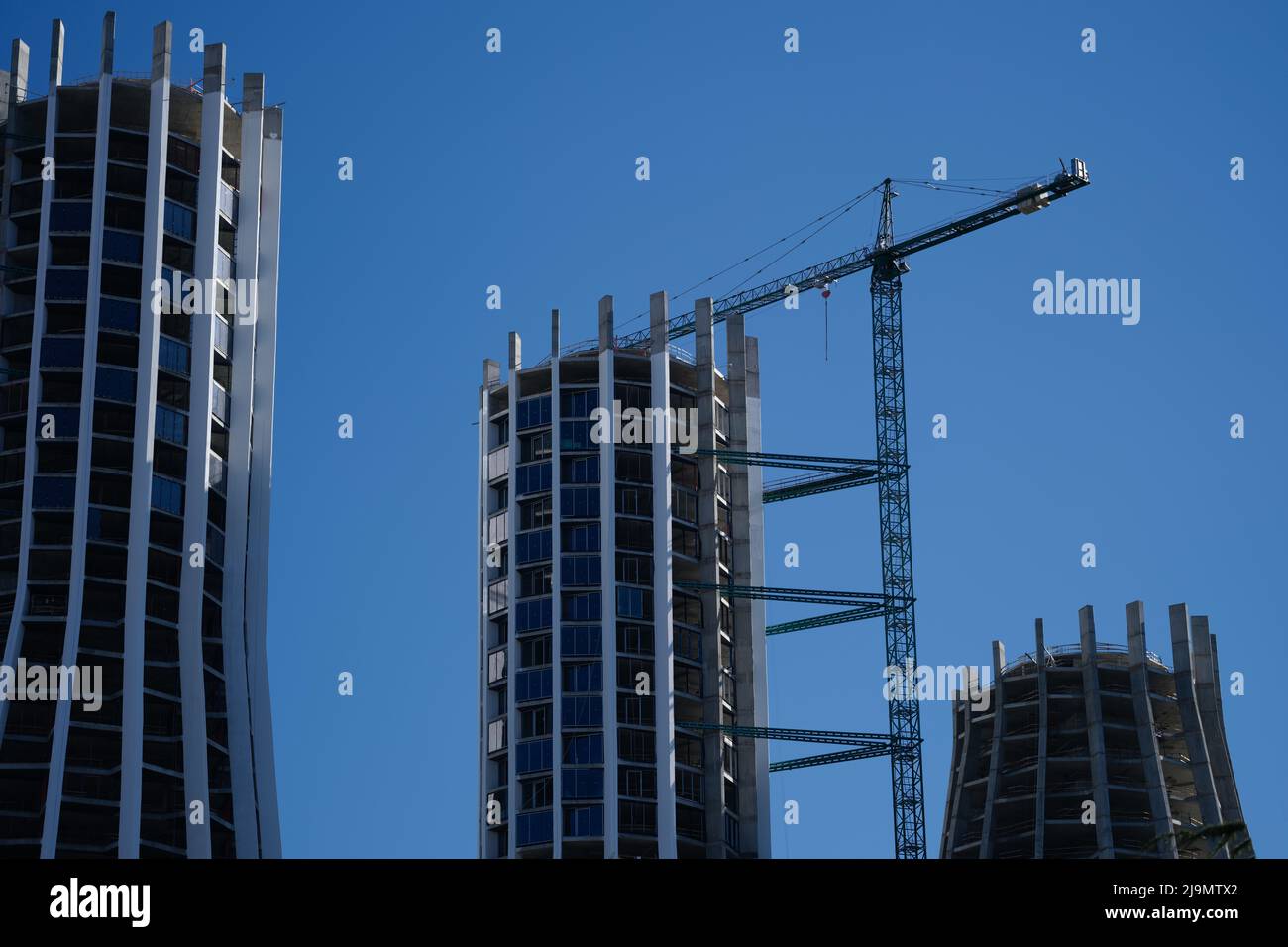 Construction crane and construction of highrise buildings Stock Photo