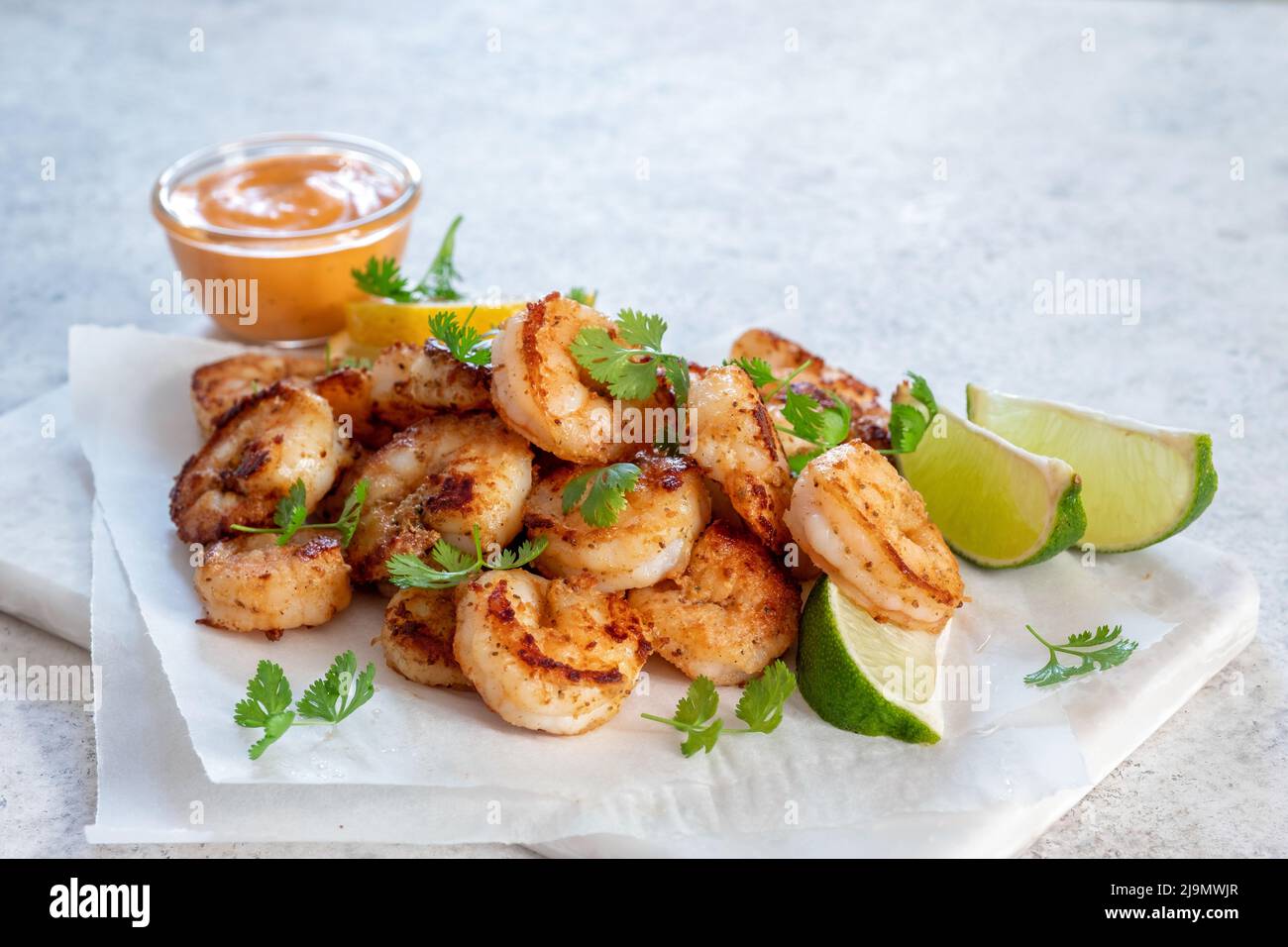Prawns Shrimps roasted with lemon and garlic on white background Stock Photo