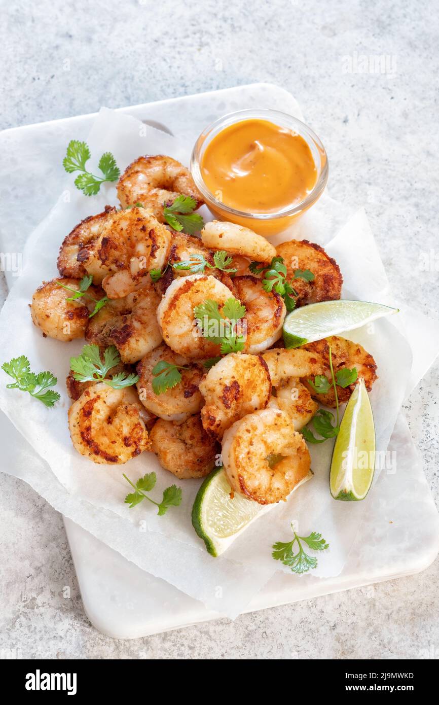 Prawns Shrimps roasted with lemon and garlic on white background Stock Photo