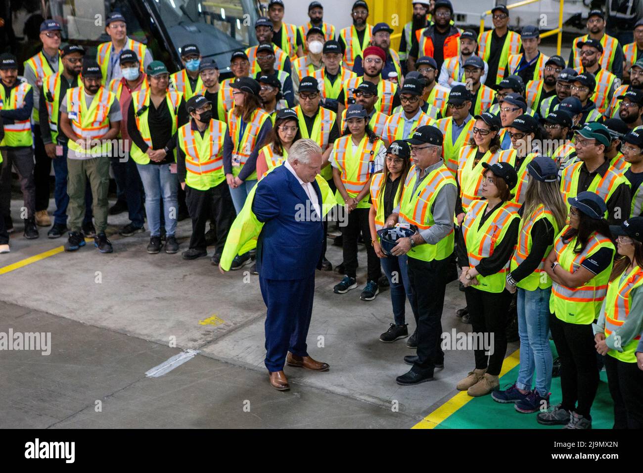 Brampton, Can. 24th May, 2022. Ontario Premier Doug Ford removes his