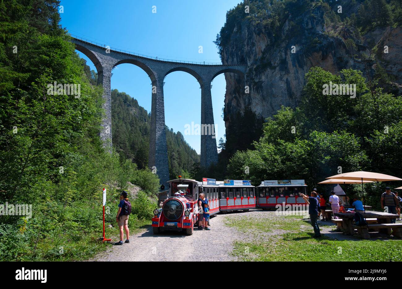 The red Rhatische Bahn train near the famous Landwasser viaduct ...