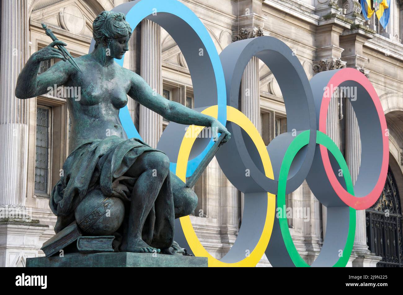 Statue of a nude female figure, “La Science”, sculpted by Jules Blanchard, located outside l’Hotel de Ville in Paris. With Olympic rings as a backdrop. Stock Photo
