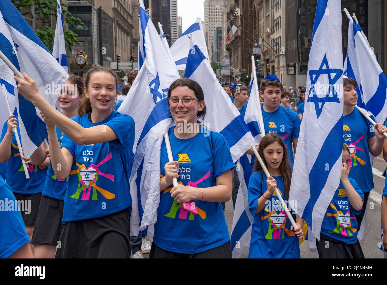 Participants holding Israeli flags march along Fifth Avenue during the
