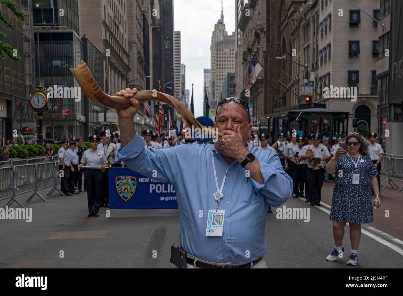 A man blowing the Shofar marches up Fifth Avenue during the Celebrate
