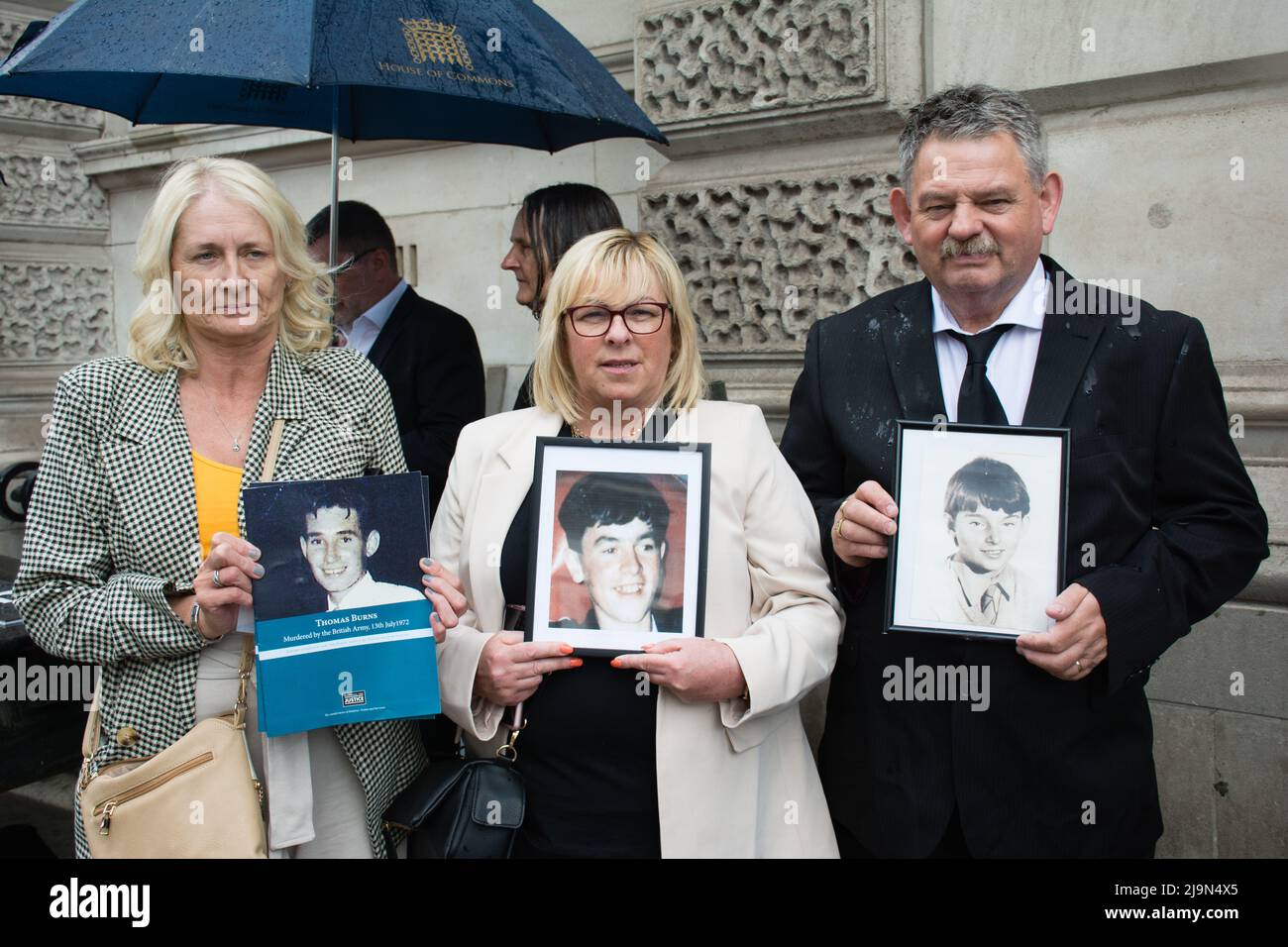 The victims of the families holding a photo of their son, brother at the British agent and soldier who murder Irish Catholic and Irish Republic exempt from prosecution. The victims of the families here to seeking justice curry a coffin in front of Downing street, London, UK. - 24 May 2022. Stock Photo