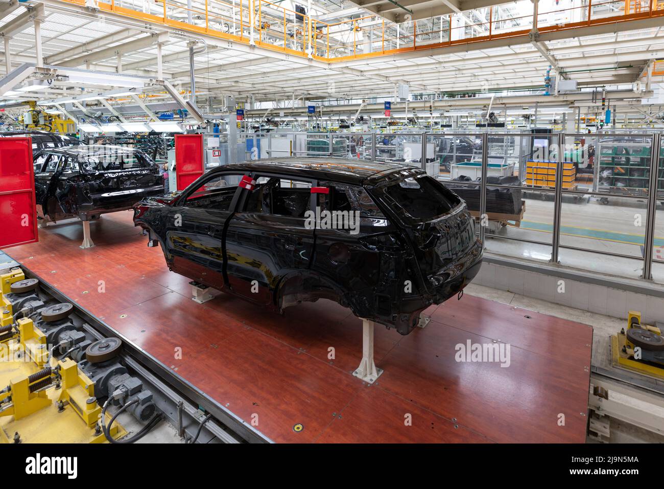 Car bodies are on assembly line. Factory for production of cars. Modern ...