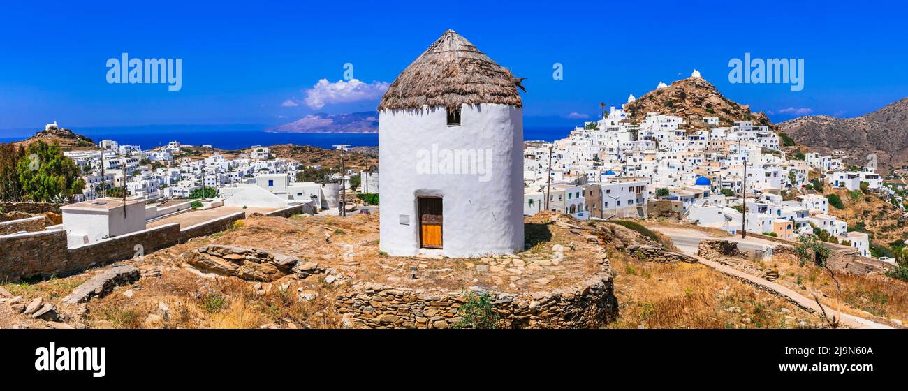 Traditional greek windmills of Ios island. View of Chora village, Greece travel. Cyclades. Stock Photo