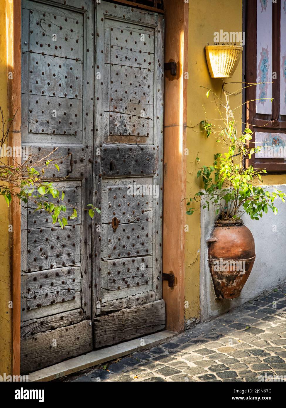 Old doors. Charming floral narrow streets of typical italian villages. Vallerano, medieval borgo of Italy in Laizo region Stock Photo