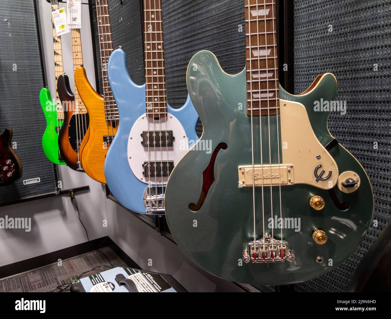 Lynnwood, WA USA - circa May 2022: View of various bass guitars for sale inside a Guitar Center musical instrument store. Stock Photo