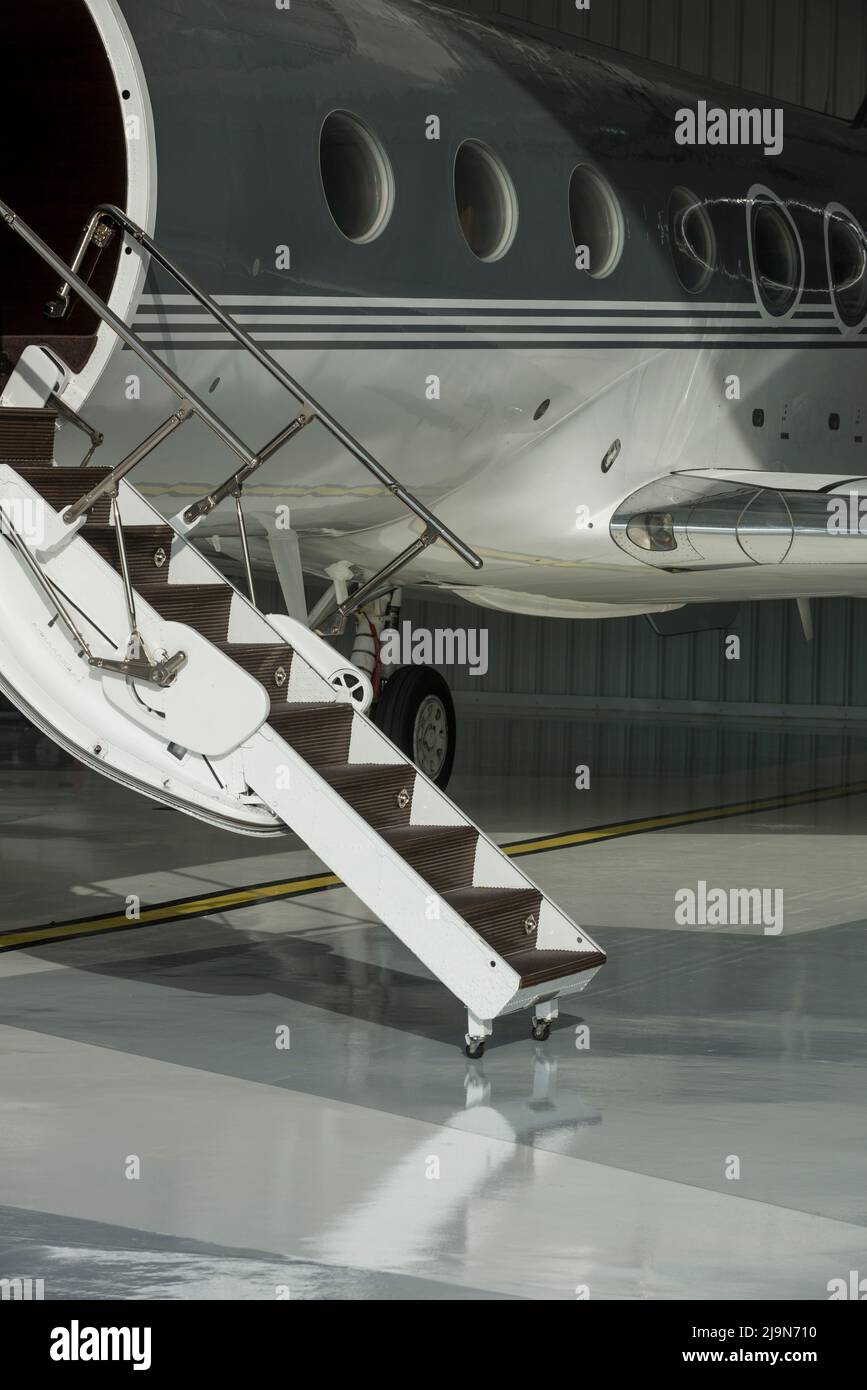 Stairs and door private jet in hangar ready to fly- stock photo Stock Photo