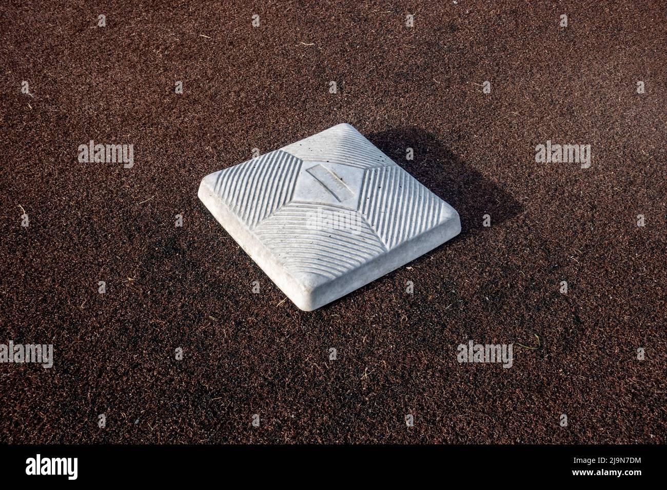 Top down, close up view of a base on a clean baseball field on a bright, sunny day Stock Photo