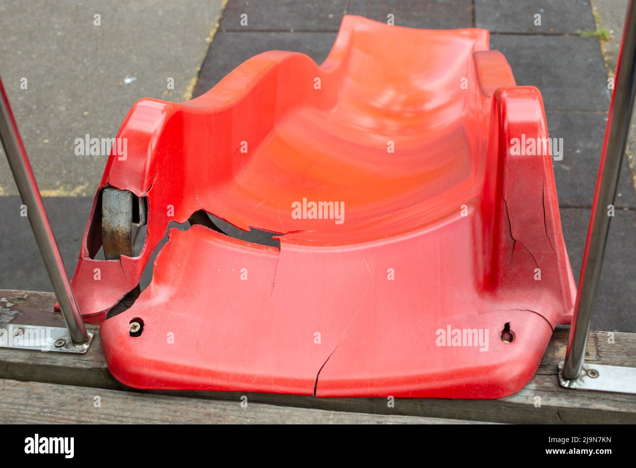 Broken Plastic Red Slide in Children Playground, Usually Found in Parks, Schools, Playgrounds