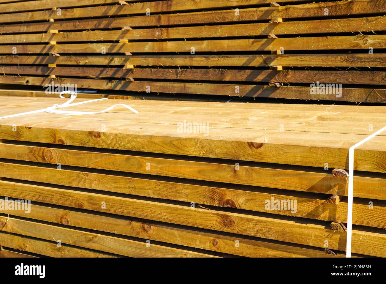 Stacked impregnated thick high quality pine wood boards for background and texture Stock Photo
