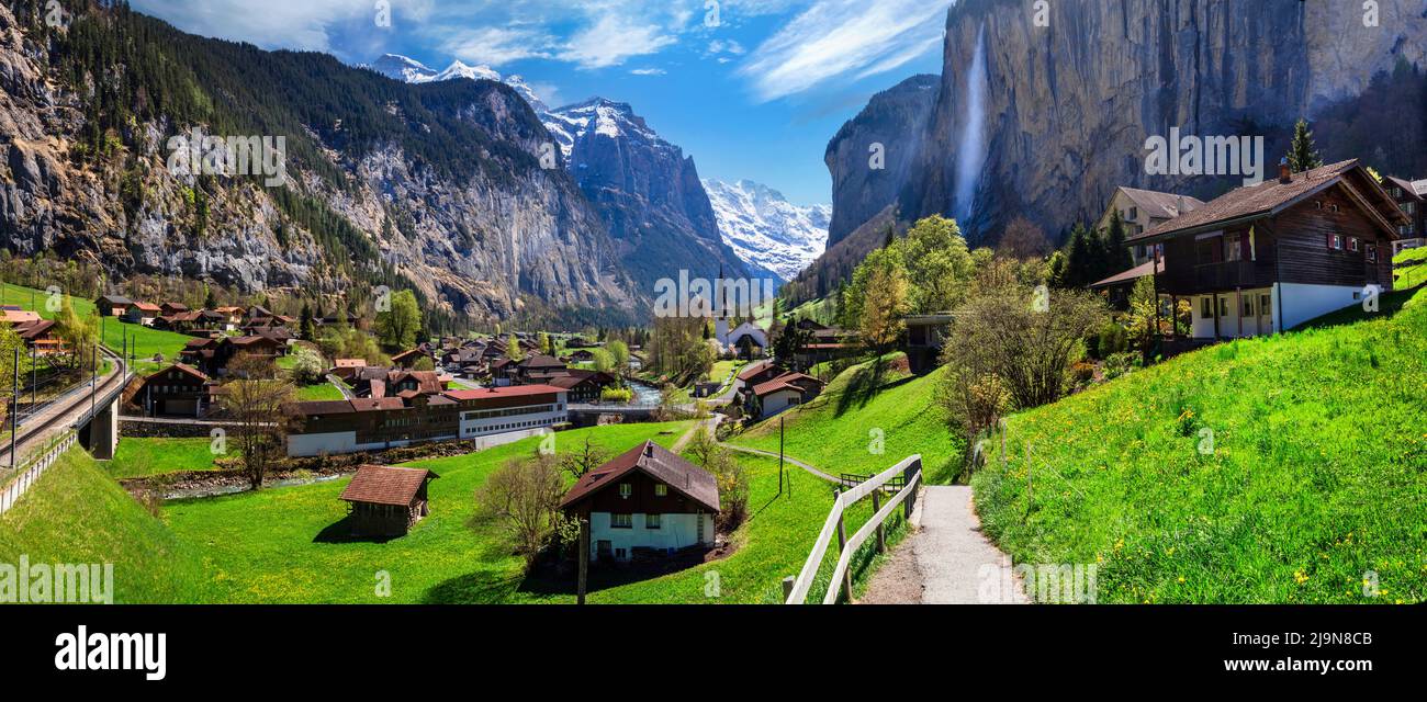 Switzerland nature and travel. Alpine scenery. Scenic traditional mountain village lauterbrunnen with waterfall  surrounded by snow peaks of Alps. Pop Stock Photo