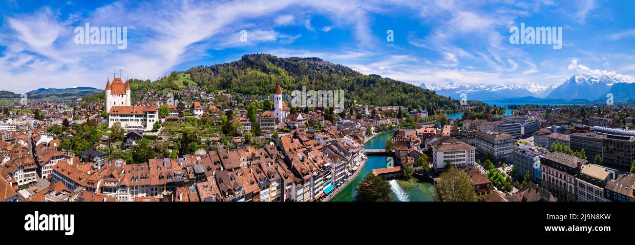 Splendid aerial panorama of Thun old town with medieval castle and Alps mountains on background. Incredible beautiful Switzerland. Stock Photo