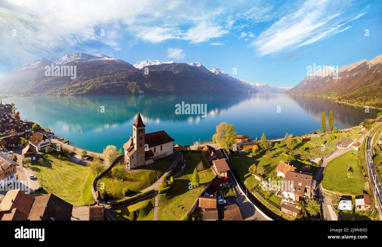Stunning idylic nature scenery of lake Brienz with turquoise waters. Switzerland, Bern canton. Aerial view with little church in the morning light Stock Photo
