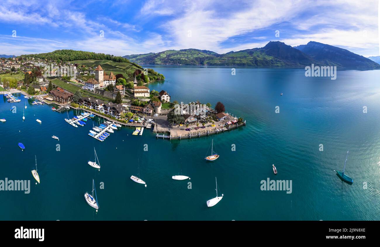 Stunning aerial drone panorama of lake Thun and the Spiez village with  medieval castle and old town in the alps in Canton Bern in Switzerland Stock Photo