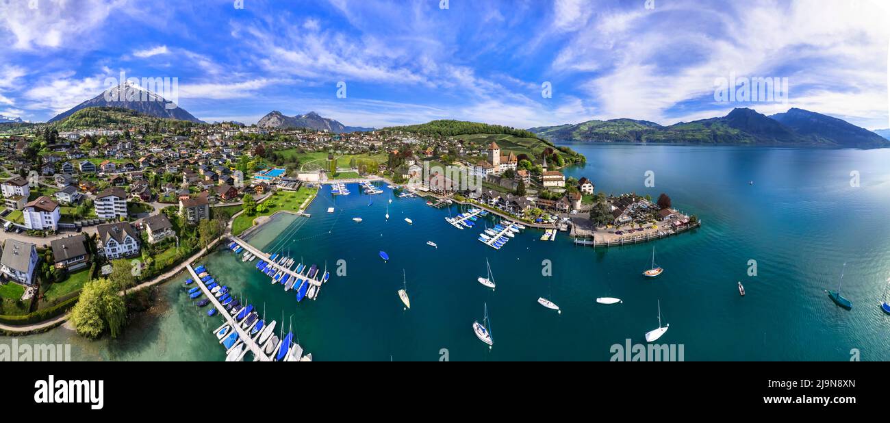 Stunning aerial drone panorama of lake Thun and the Spiez village with  medieval castle and old town in the alps in Canton Bern in Switzerland Stock Photo