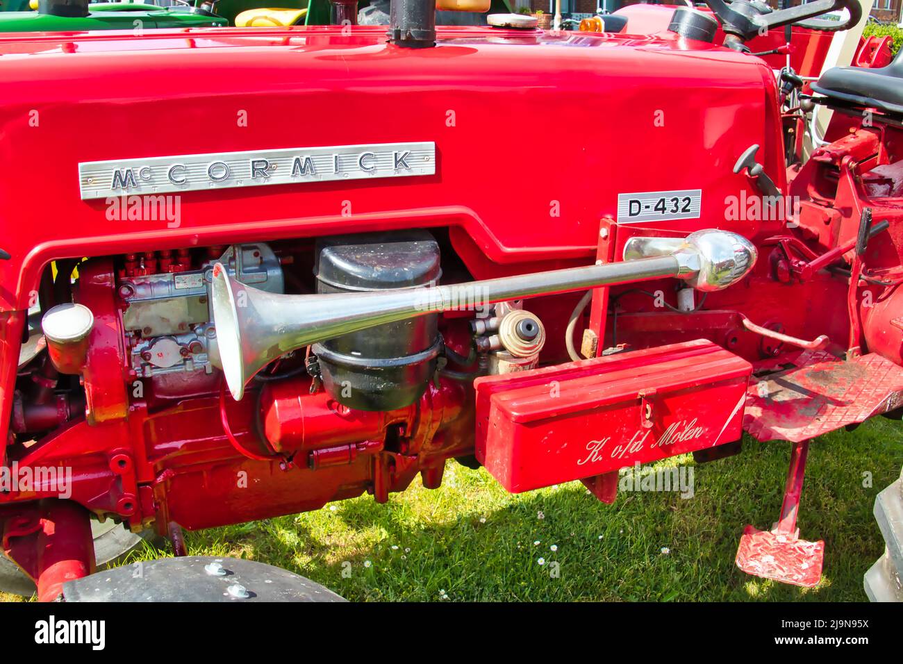 Engine and classic chrome horn of a vintage McCormick D423 tractor at a classic car show in Uithuizen, Groningen, the Netherlands Stock Photo