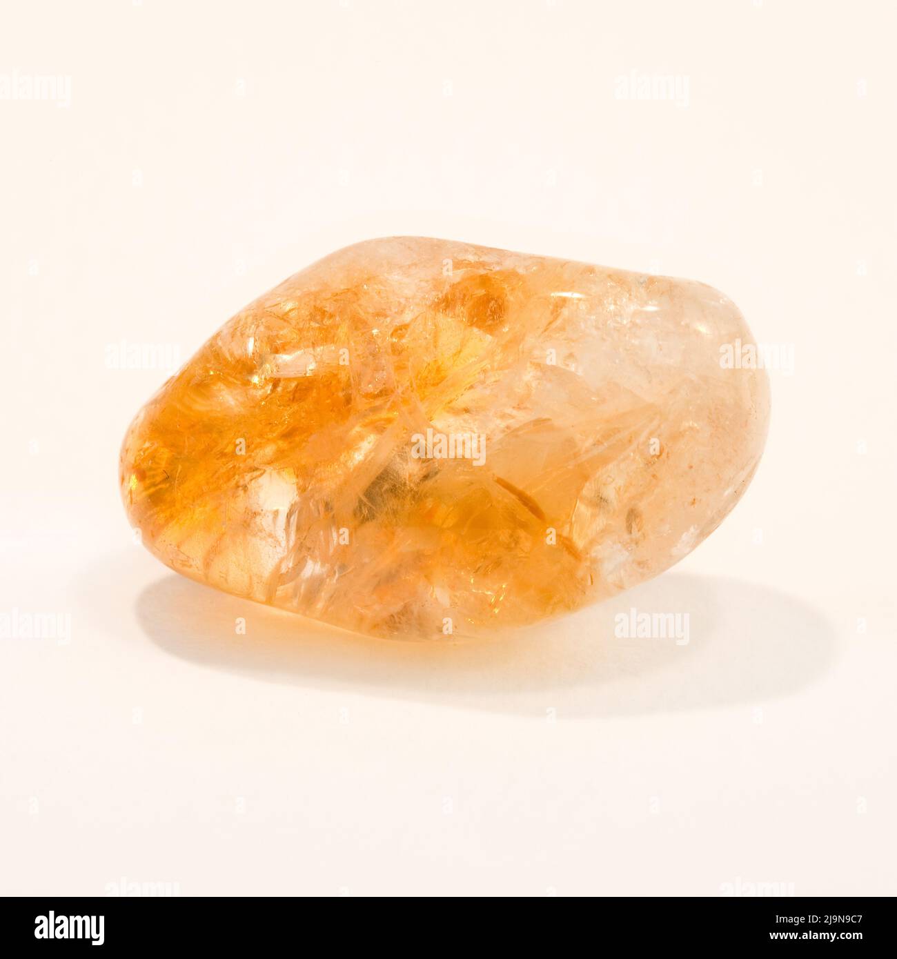 Macro close up colour photograph of a polished ' Citrine ' a semi precious crystal gemstone used in crystal healing therapy Stock Photo