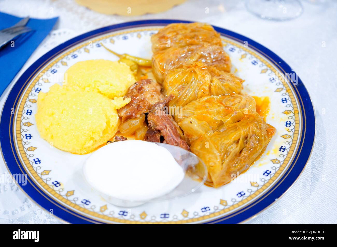 sarmale with polenta, sour cream, ribs and hot peppers, in a restaurant Stock Photo