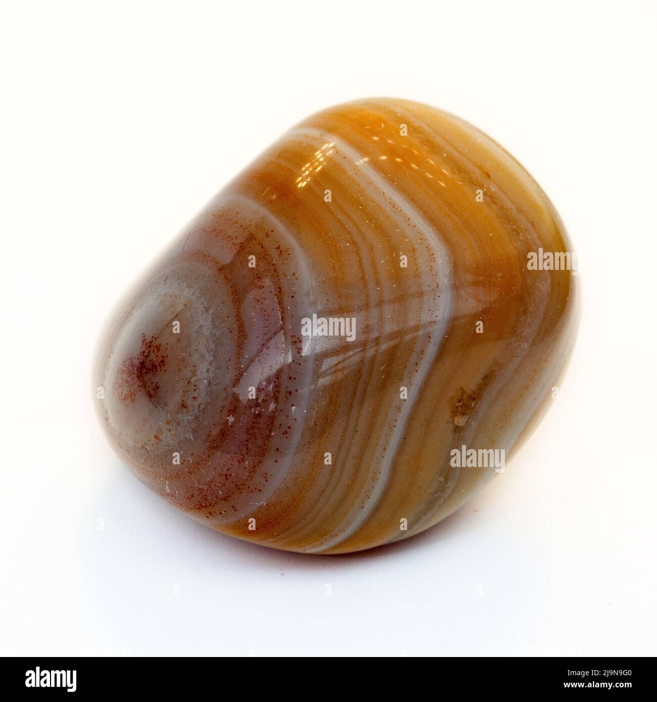Macro close up colour photograph of a polished ' Sardonyx ' a semi precious crystal gemstone used in crystal healing therapy Stock Photo