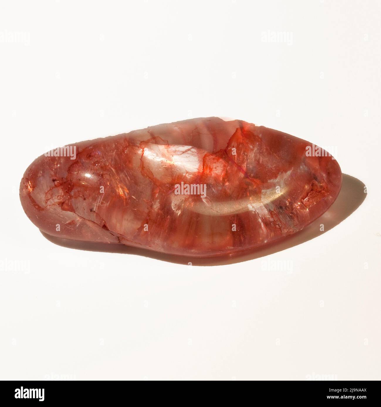Macro close up colour photograph of 'Red Crackle Quartz' a semi precious crystal gemstone used in crystal healing therapy Stock Photo