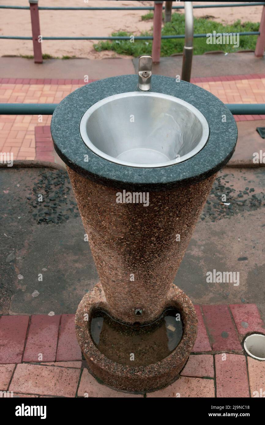 A close up view of a water fountain on the walk way near the beach. Stock Photo